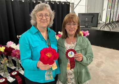 Sylvie Perron présentant à Lucie Pepin le ruban gagnant pour Semi-double (ex-aequo) : Cherry Ruffles, classe 1